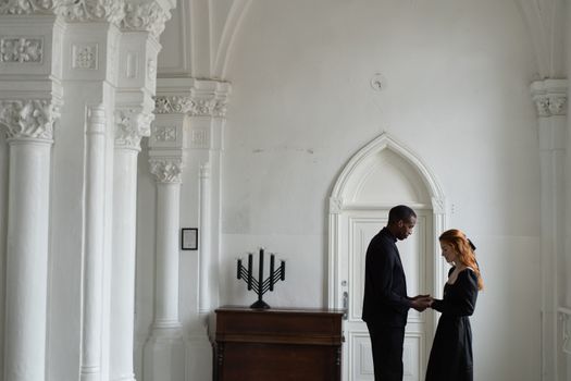 Man in Black Suit Standing Beside Woman in White Dress