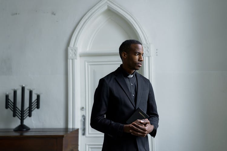 A Pastor Holding A Bible