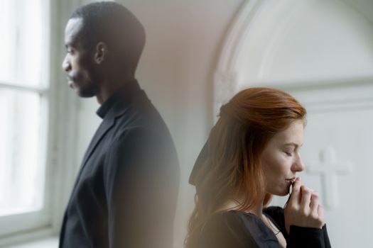 A Man And a Woman Standing Back to Back with Each Other