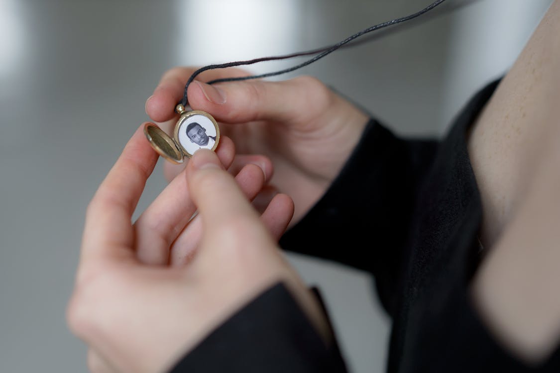 Photo of a Man in Round Locket Necklace 