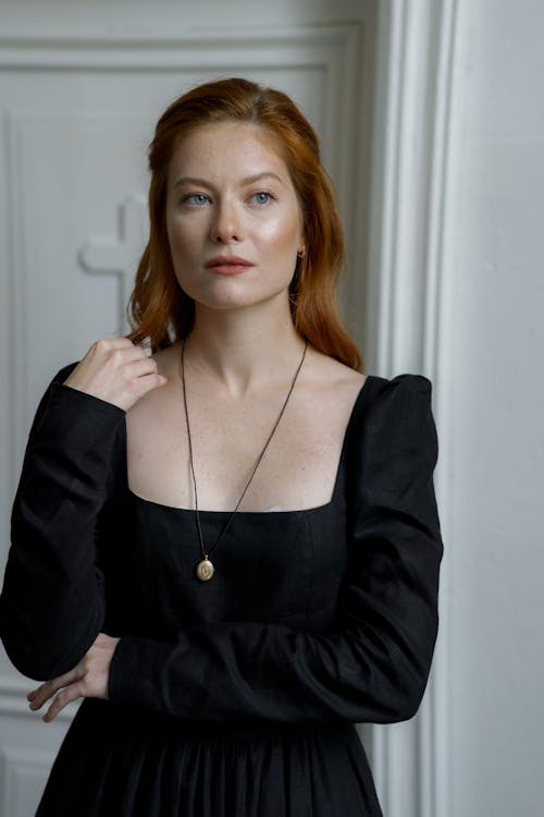 Portrait of a Woman with Red Hair Wearing a Black Dress