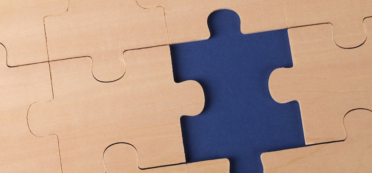 An unfinished jigsaw puzzle with a missing piece