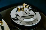 Creative composition of precious golden wedding rings placed on steel motorbike ignition switch