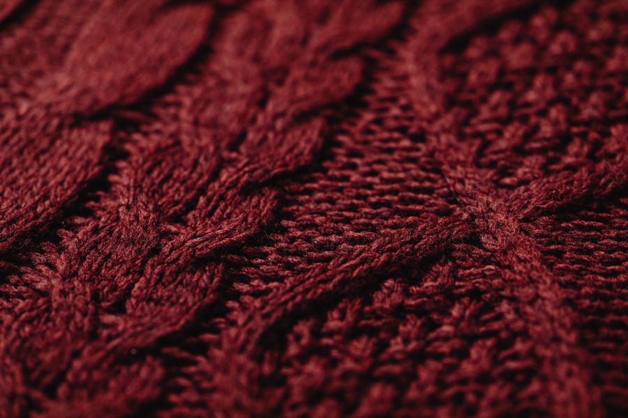 Woven textile piece with geometric red and cream pattern