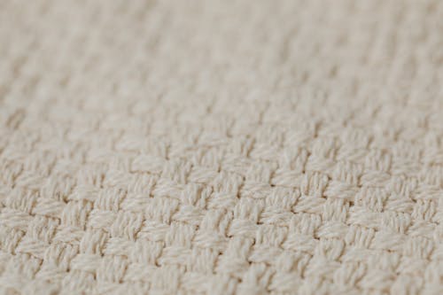 Close-Up Shot of a Beige Knitted Textile