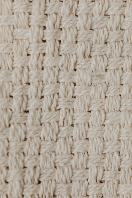 Close-Up Shot of a Beige Knitted Textile