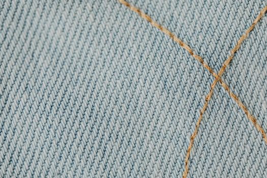 Detailed close-up showing intricate stitching on blue denim fabric.