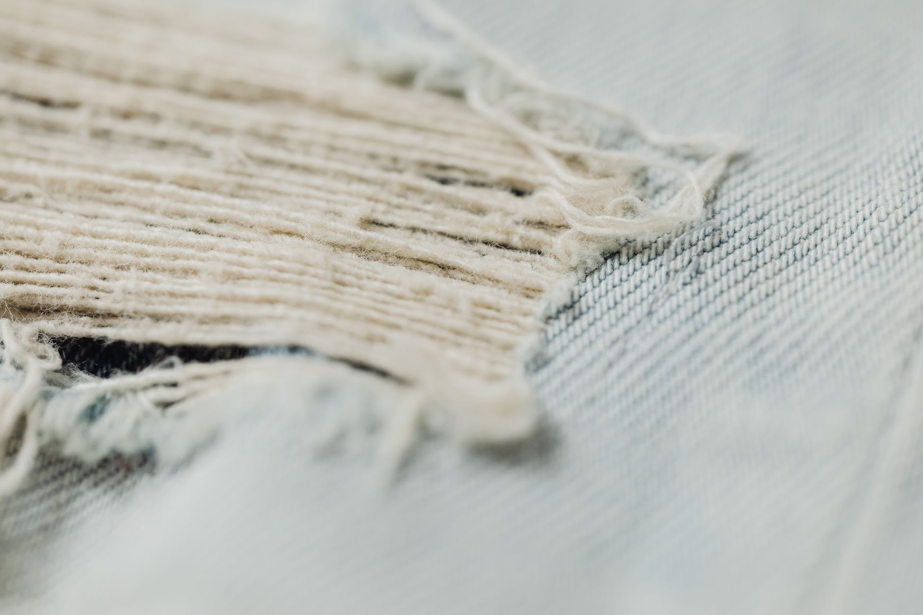 Close-up of a garment seam showing fraying and depleted seam allowance