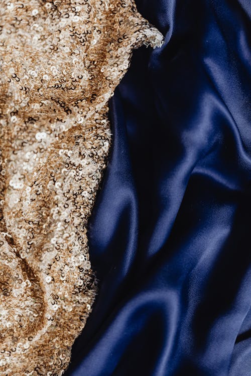 Close-Up Shot of a Dark Blue Silk and Gold Sequins