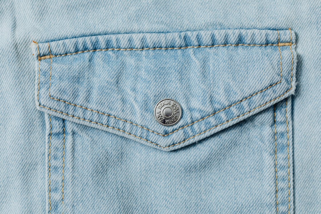 Close-Up Photo of Denim Textile with a Silver Button · Free Stock Photo