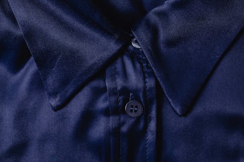 Close-Up Photo of a Blue Textile with a Button