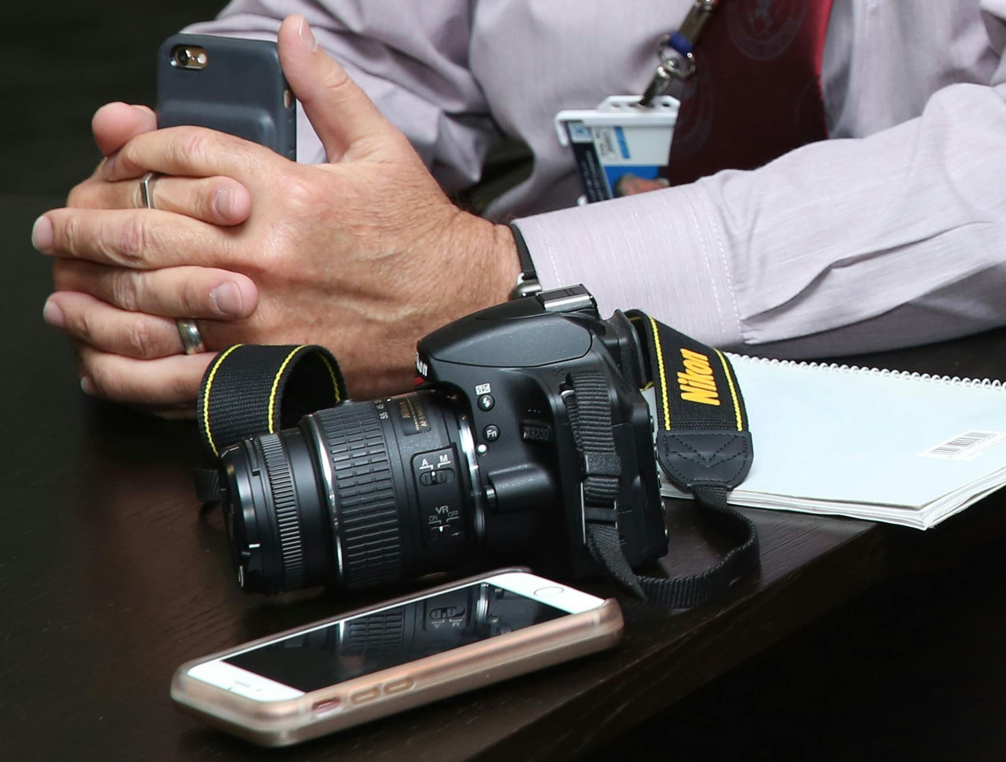 black nikon dslr camera beside person s hands