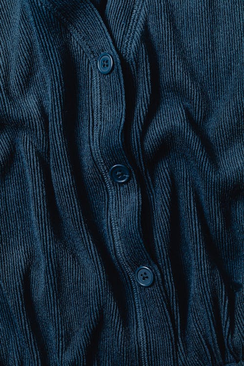 Close-Up Photo of a Blue Fabric with Buttons
