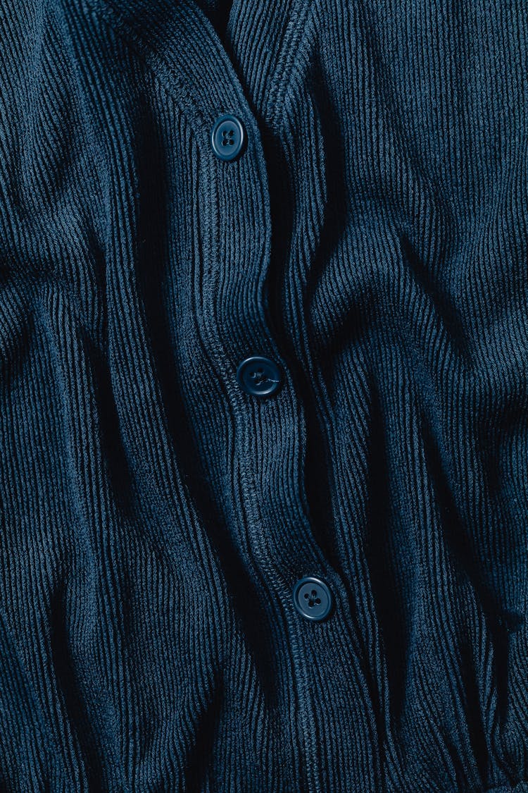 Close-Up Photo Of A Blue Fabric With Buttons