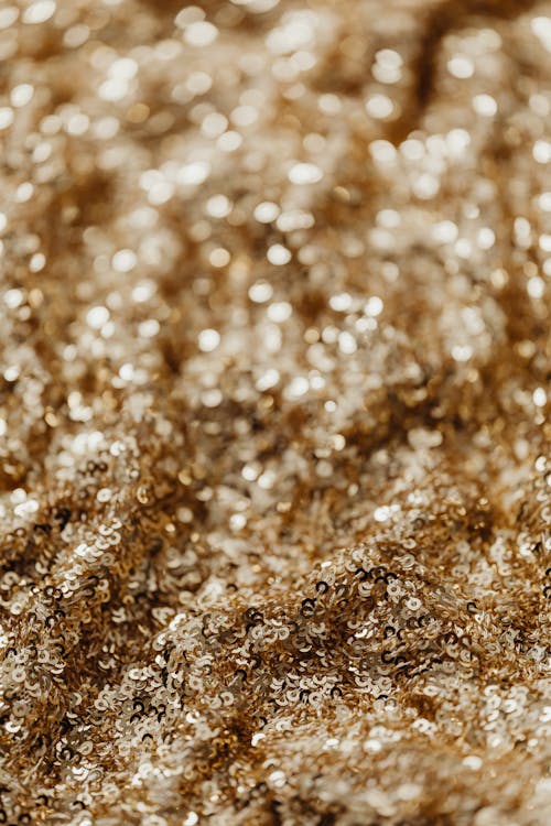 Selective Focus Photo of Gold Sequins