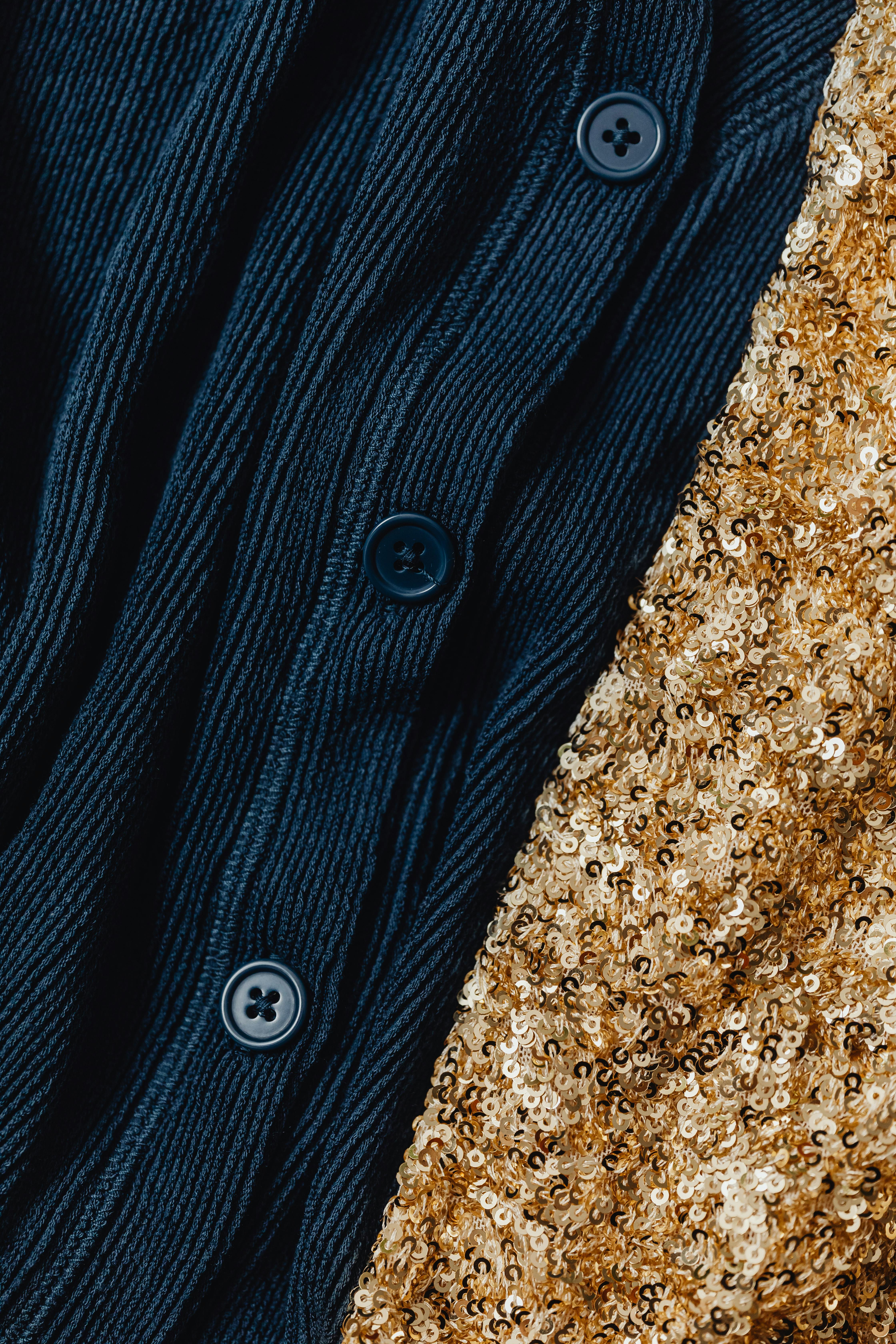 close up shot of a dark blue knitwear and gold sequins