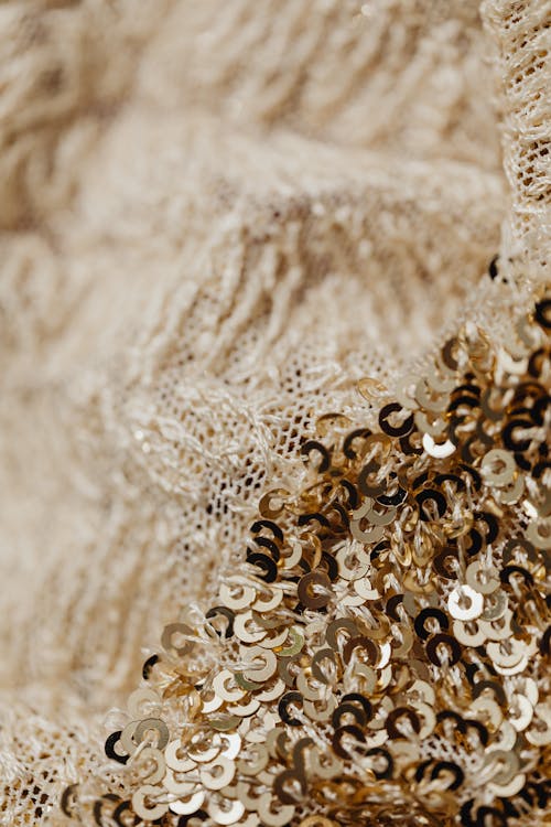 Selective Focus Photo of Woven Fabric with Golden Sequins