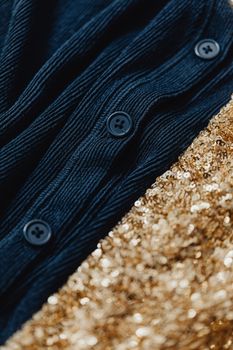 Detailed close-up of textured blue corduroy and sparkling gold sequins for fashion design.