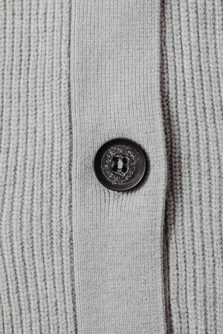 Close-Up Shot Of Gray Knit Textile With Button