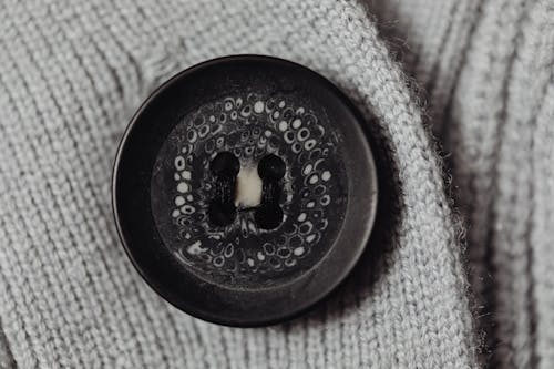 Free Close-Up Shot of Gray Knit Textile With Button Stock Photo