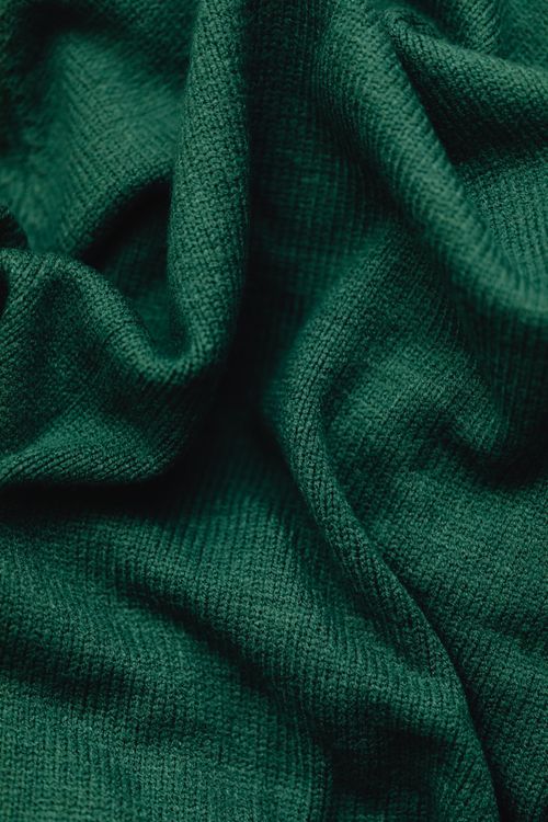 Free Detailed close-up of a green fabric showcasing its texture and weave. Stock Photo