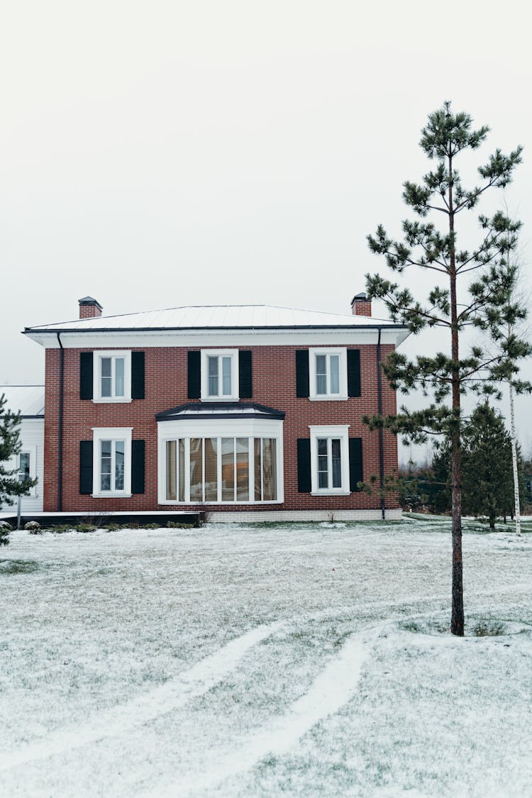 Brown And White Concrete House On Snow Covered Ground