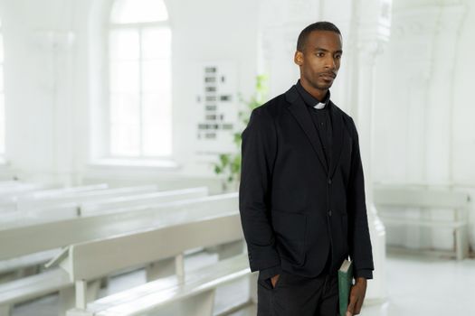 Man in Black Suit Standing Near White Wall