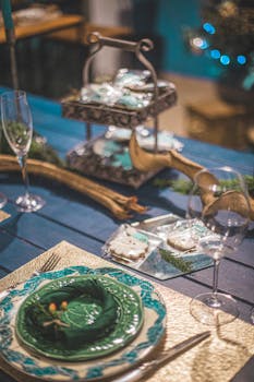 Festive table setting with elegant decorations and glassware, perfect for a Christmas celebration.