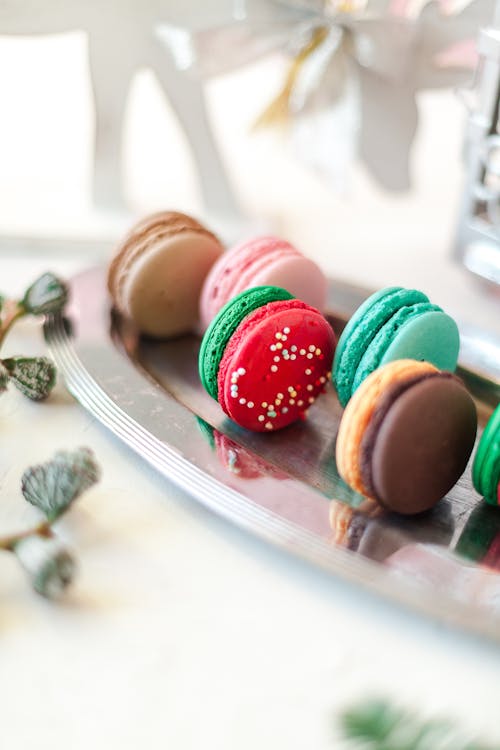 Yummy macaroons on steel tray in light room