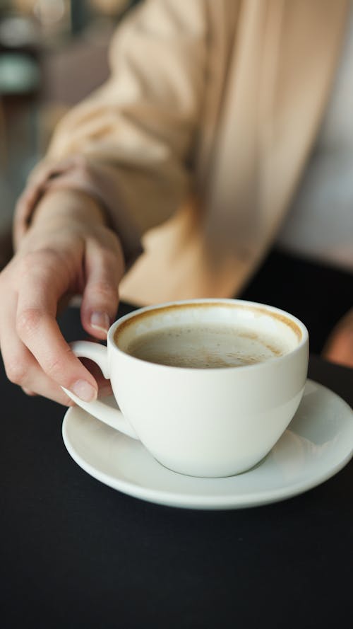 Free Person Holding a Cup of Coffee Stock Photo