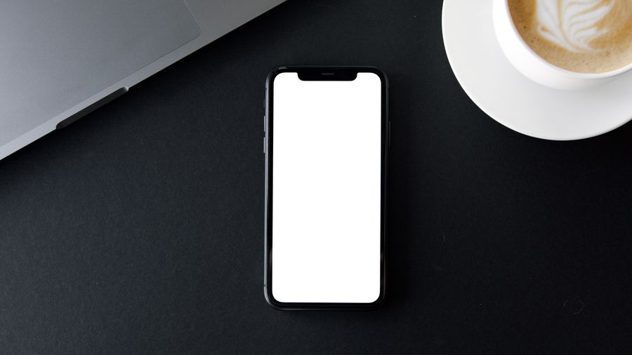 Smartphone and laptop setup for WhatsApp customer communication