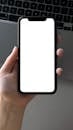 Person Holding Iphone with Blank Screen