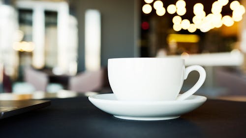 Free White Ceramic Cup and Saucer on Table Stock Photo