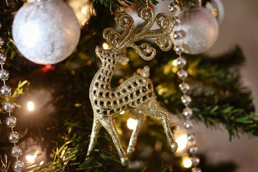 Close-up of a shimmering golden reindeer ornament hanging on a decorated Christmas tree.