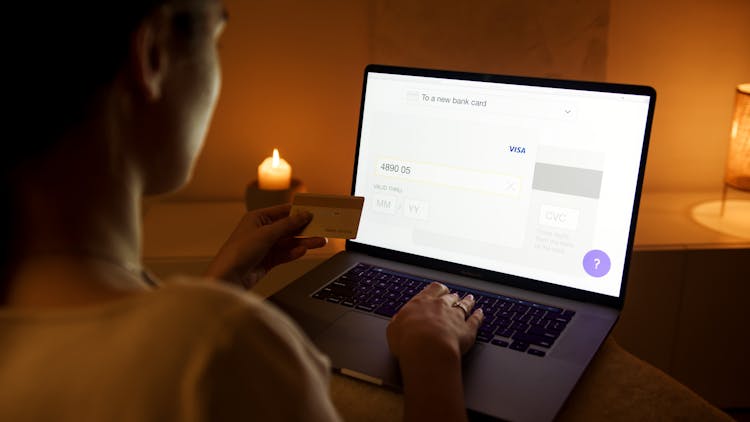 Woman In White Shirt Using Laptop Doing Online Shopping