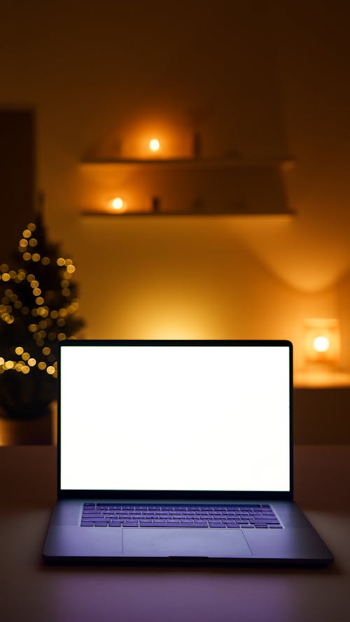Photograph of a Laptop Near Orange Lights