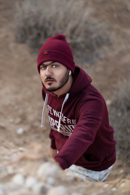 High-Angle Shot of a Man in a Maroon Hoodie Looking at the Camera