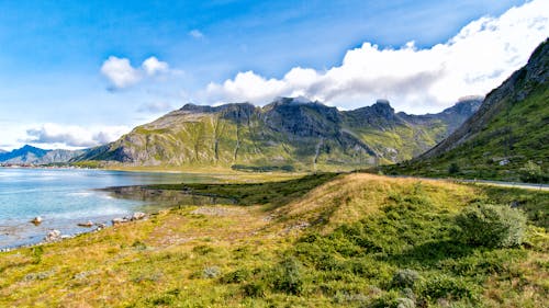 Body of Water Beside Mountains