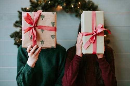 2 Person Holding Christmas Gifts