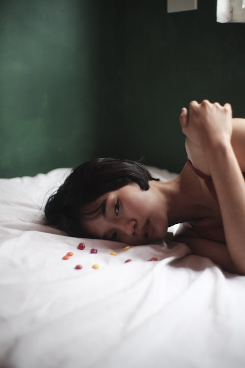 Sleepy Asian woman lying on bed