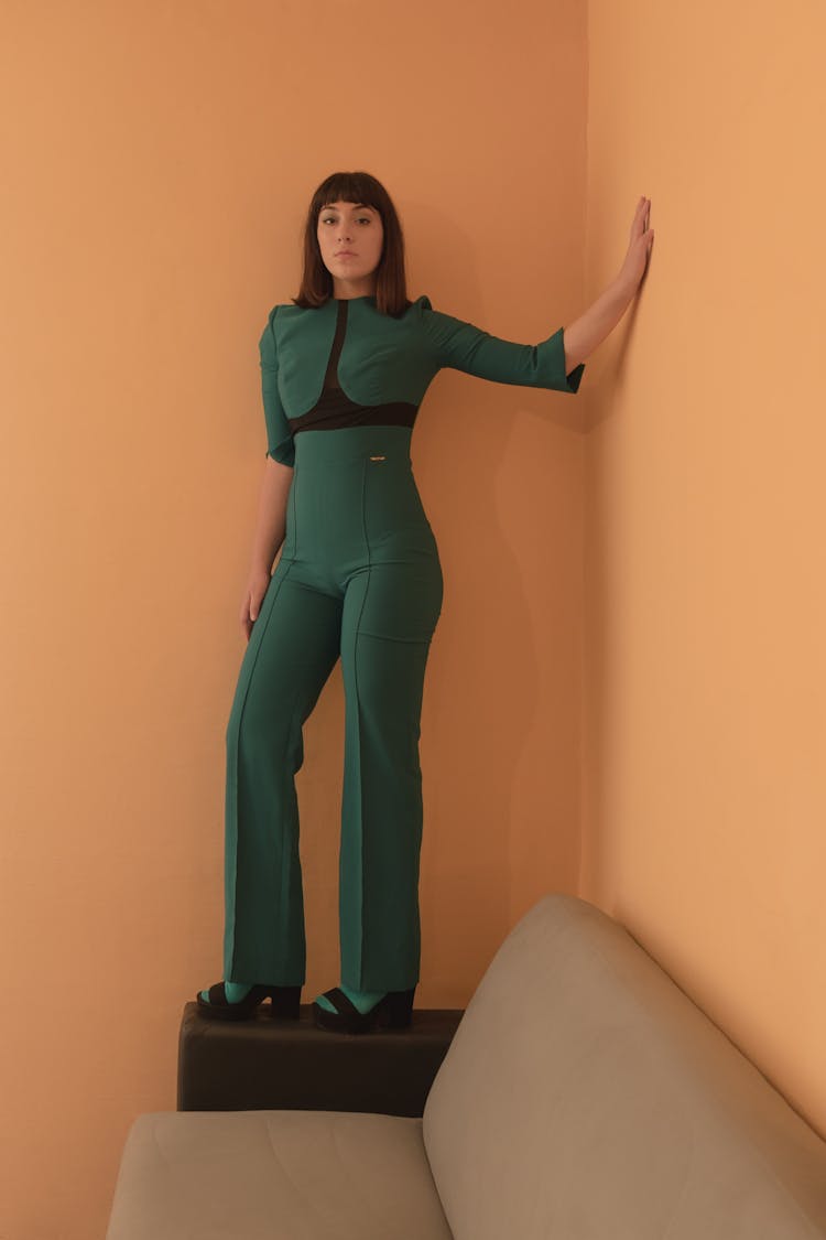 A Woman Standing While Touching The Wall