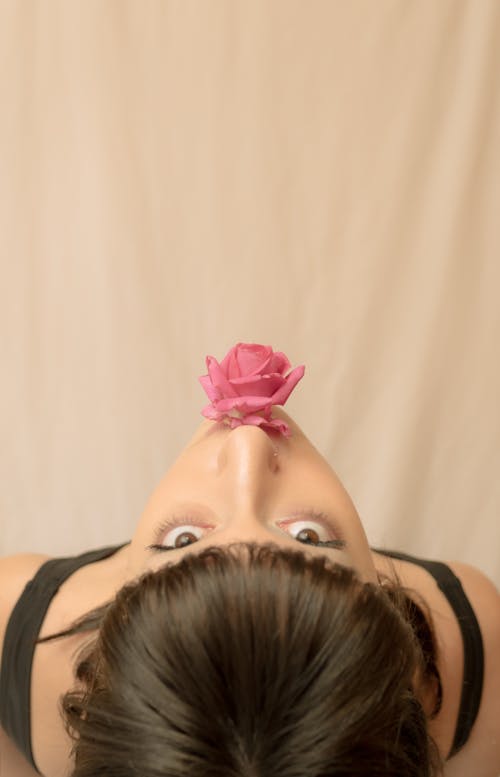 Free Woman in Black Tank Top With Pink Flower on Her Lips Stock Photo