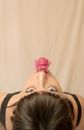 Woman in Black Tank Top With Pink Flower on Her Lips
