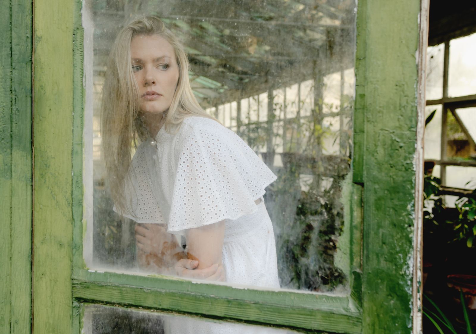 A woman in a white broderie anglaise dress — the return of eyelet for summer 2026