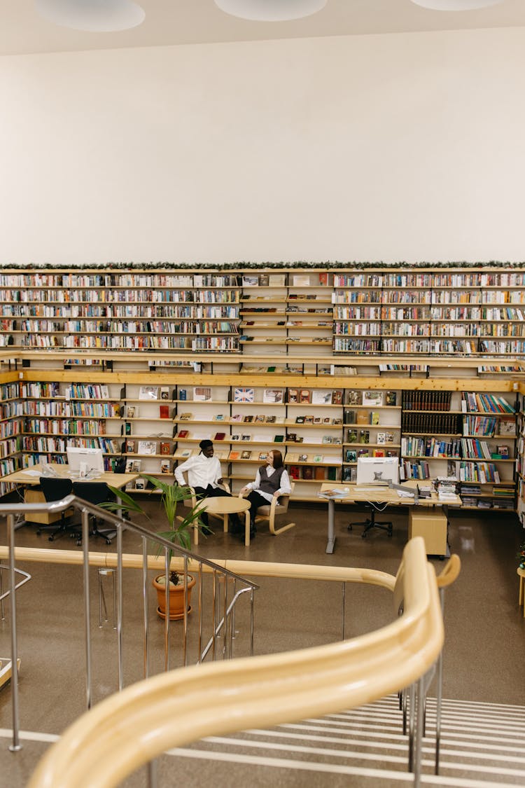 Man And Woman Sitting On The Library