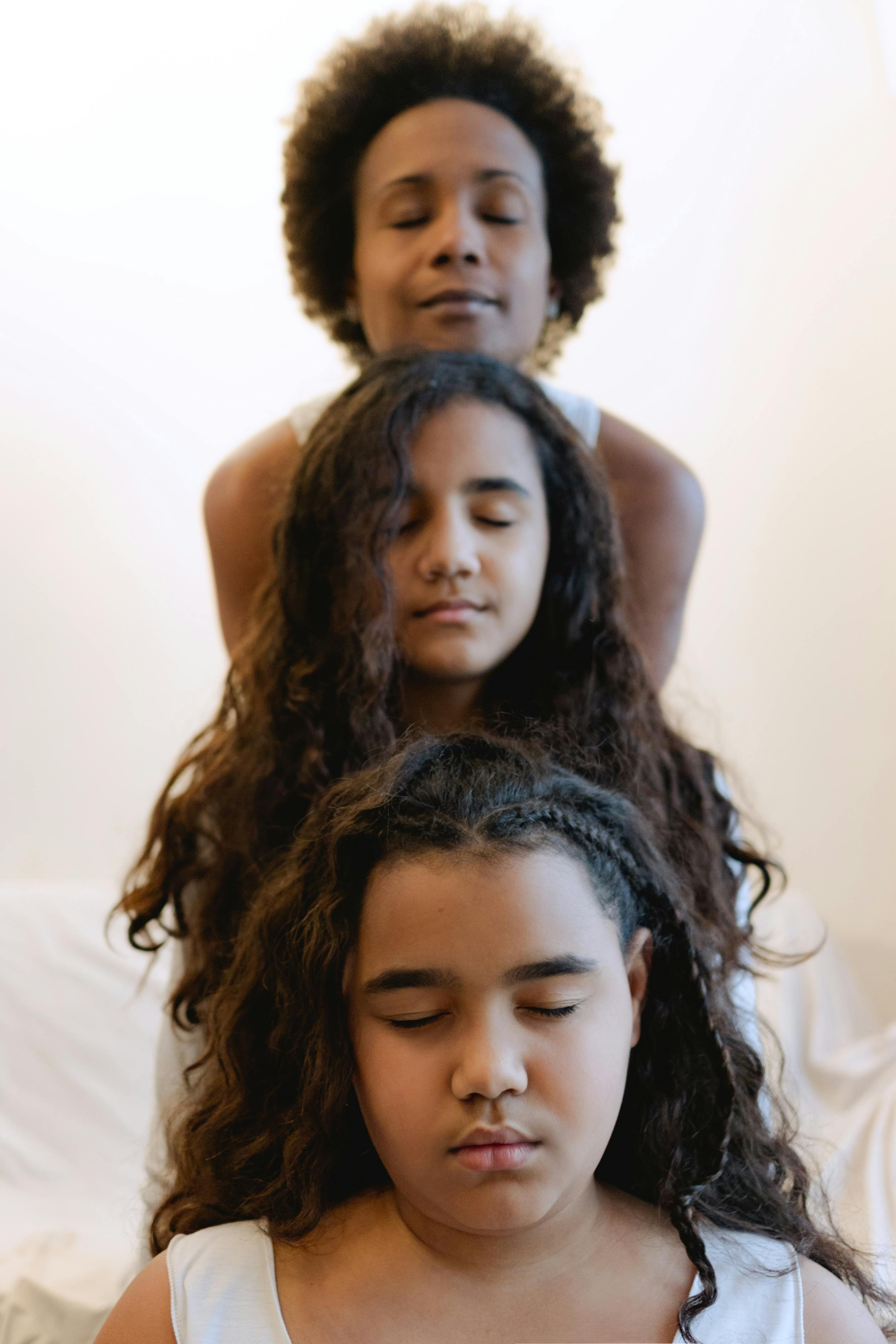 a family sitting on the bed