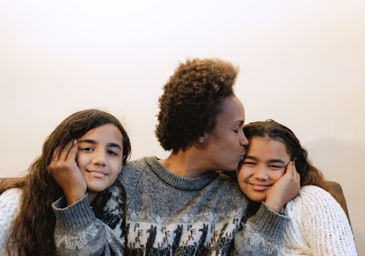 Mother Kissing Her Daughters