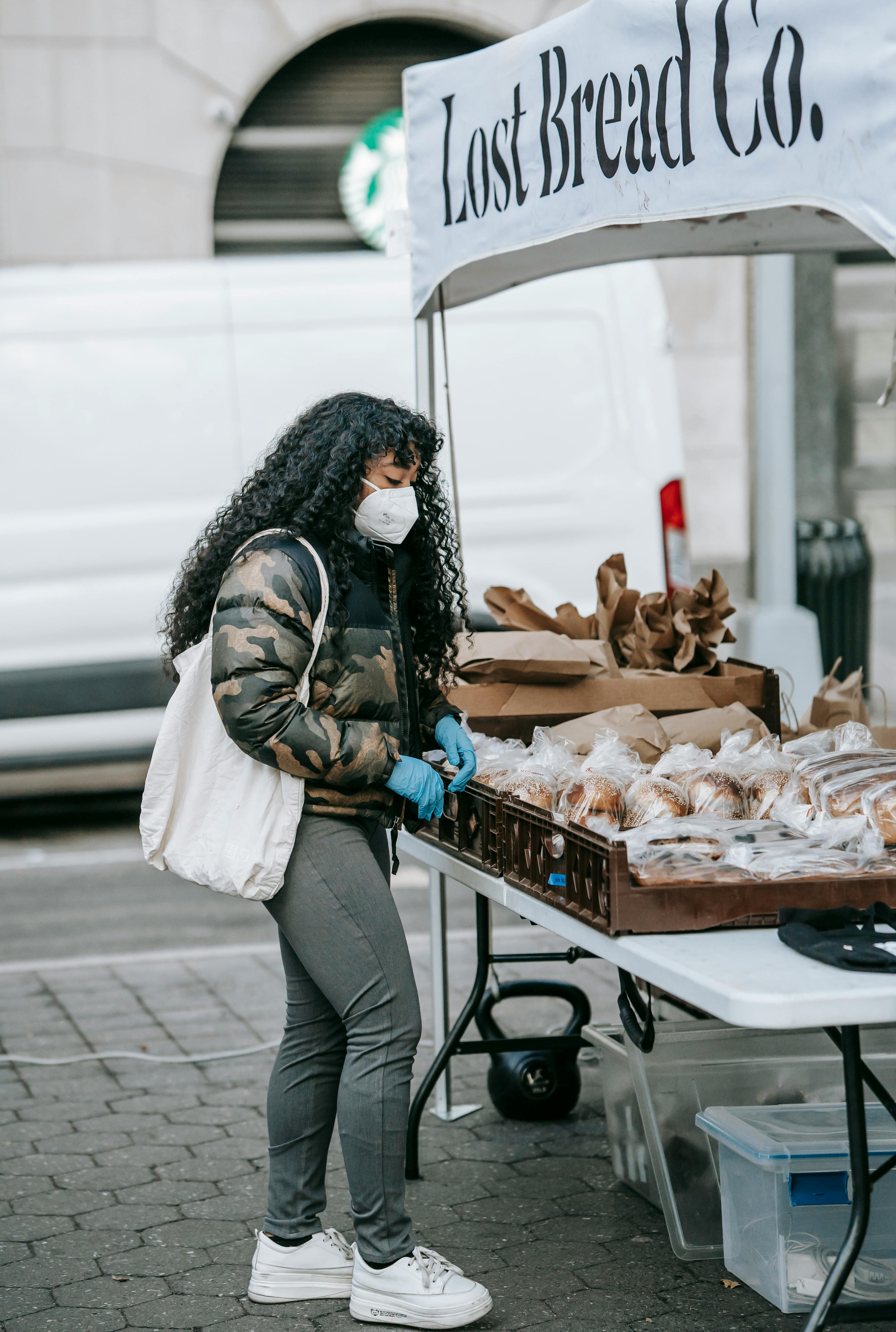 black woman choosing fresh bread in street market
