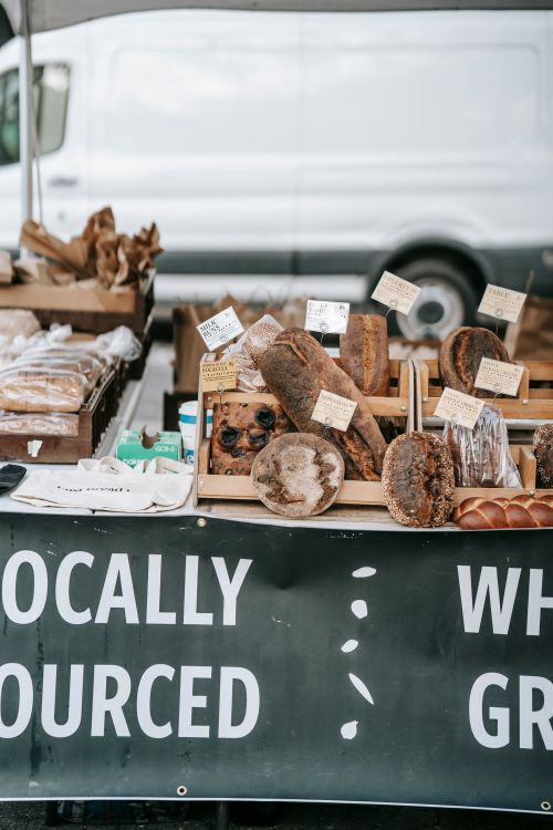 Free Different delicious fresh breads and loaves placed on wooden trays in small street bakery Stock Photo