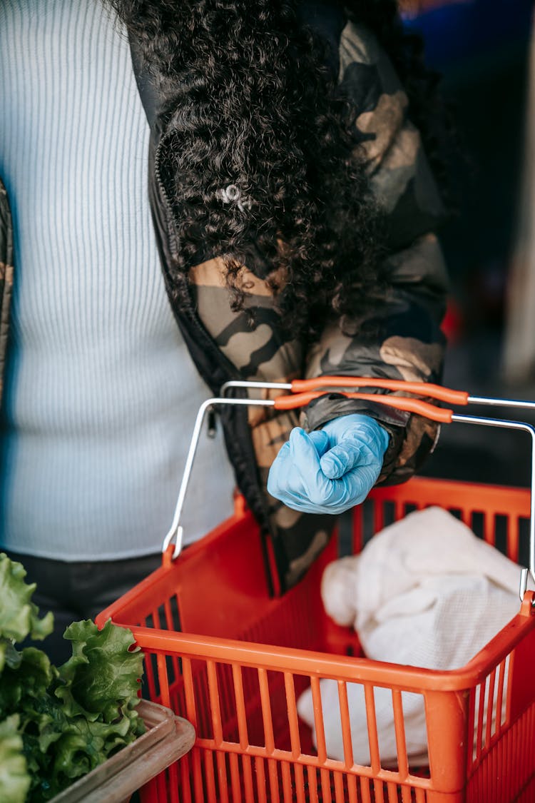 Crop Woman In Glove With Shopping Basket